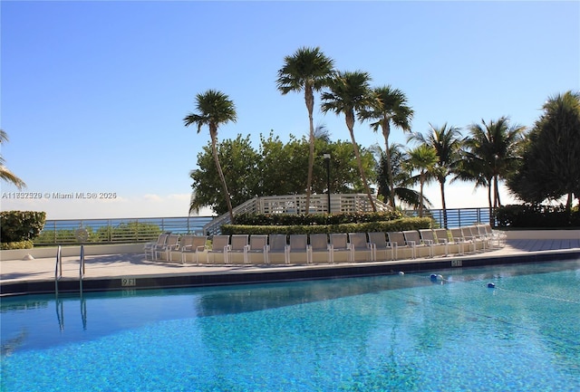 view of pool featuring a water view