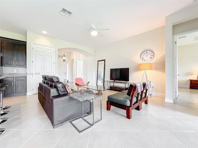 living room with light tile patterned floors and ceiling fan