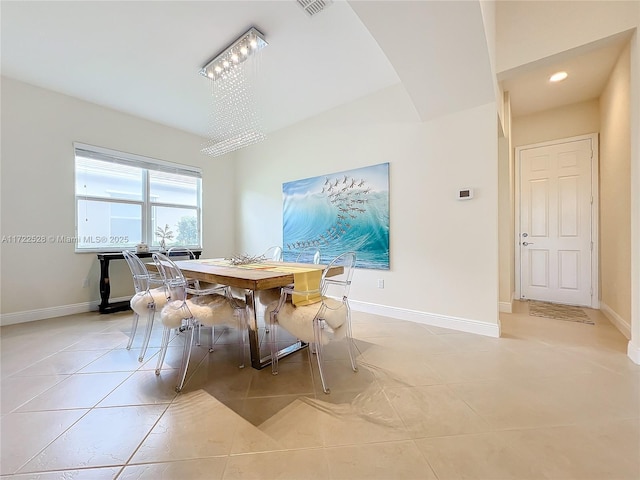 dining room featuring light tile patterned floors and an inviting chandelier