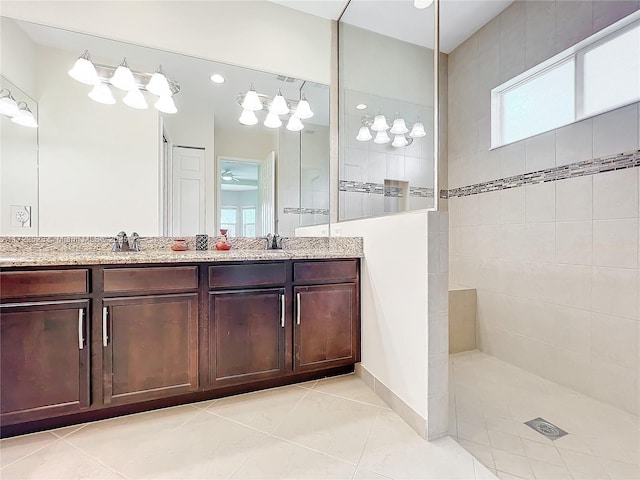 bathroom featuring tile patterned floors, ceiling fan, vanity, and tiled shower