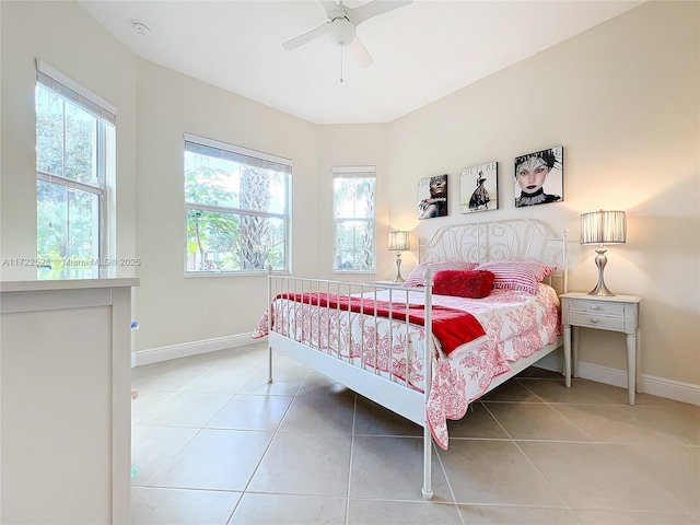 bedroom featuring multiple windows, ceiling fan, and tile patterned flooring