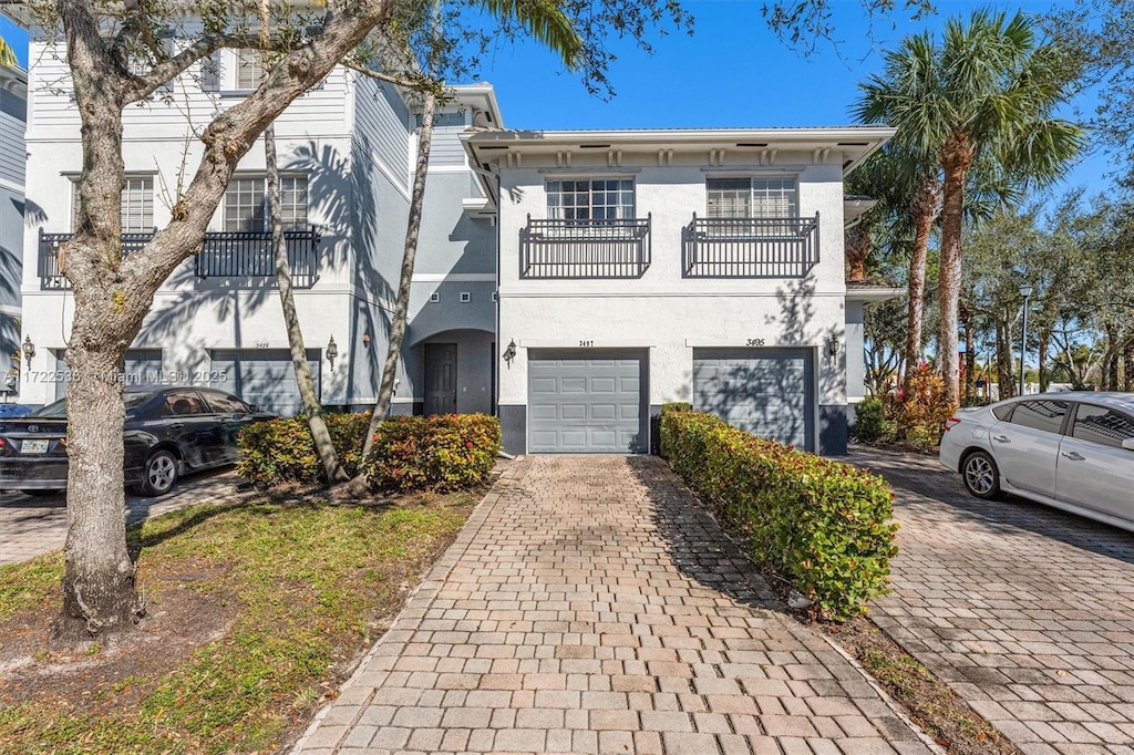 view of front of home with a balcony and a garage