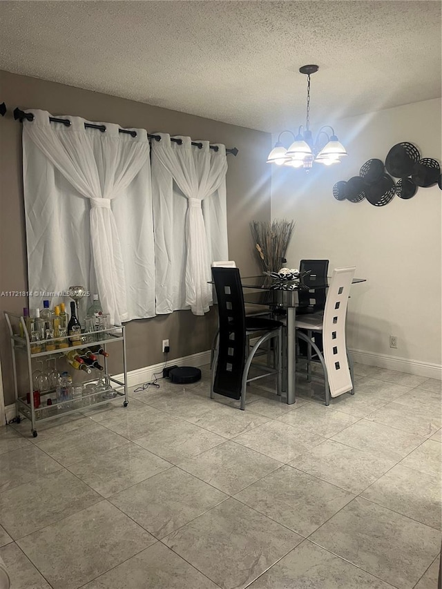 dining area featuring a textured ceiling and an inviting chandelier