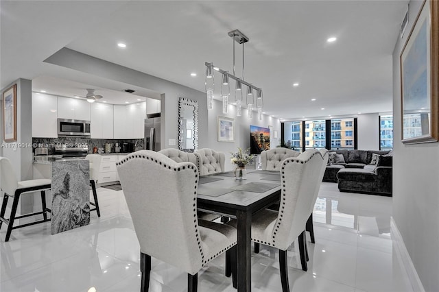 tiled dining area featuring ceiling fan