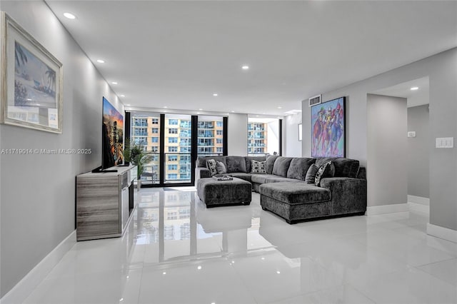 living room with expansive windows and light tile patterned floors