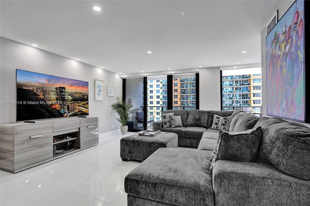 living room featuring expansive windows and light tile patterned flooring