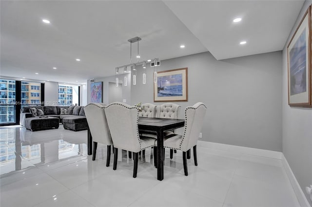 dining space with expansive windows and light tile patterned floors