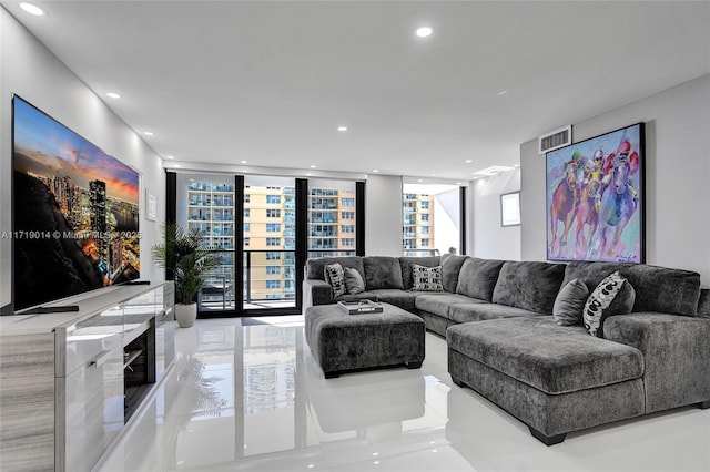 living room with light tile patterned floors and expansive windows