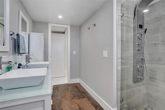 bathroom featuring an enclosed shower and vanity