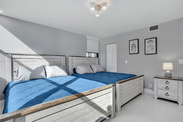 bedroom with light tile patterned floors and a closet