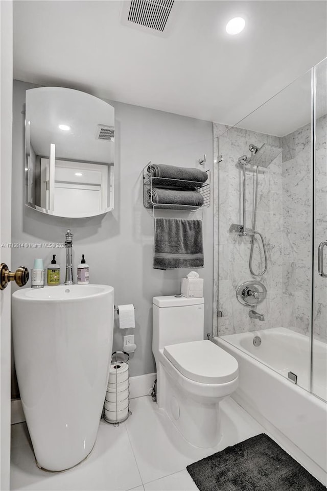 bathroom with toilet, tile patterned floors, and enclosed tub / shower combo