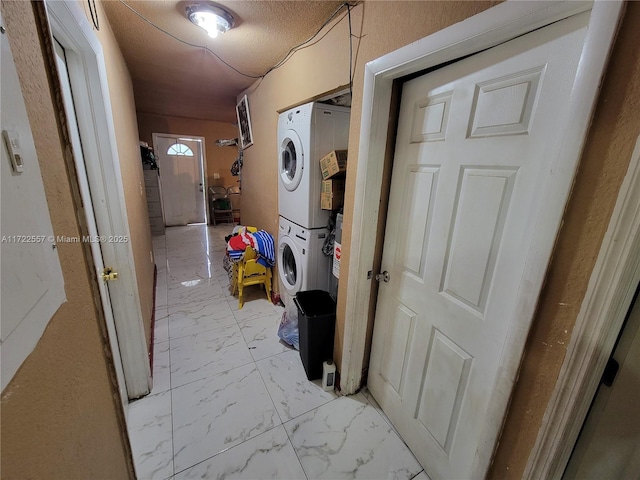 651 SW 5th St, Homestead, FL 33030 - laundry room featuring stacked washer / dryer and light marble finish floors