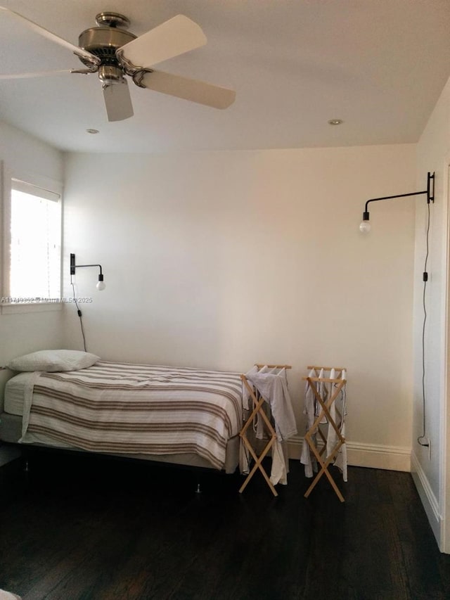 bedroom with dark hardwood / wood-style floors and ceiling fan