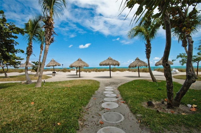 view of community with a water view and a yard