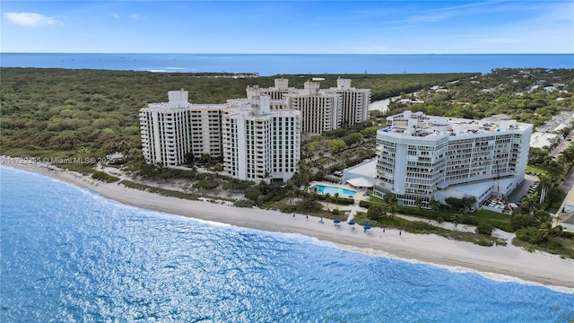 birds eye view of property featuring a water view and a beach view