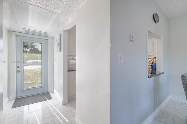 interior space with a textured ceiling