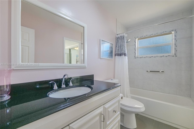 full bathroom with tile patterned floors, shower / tub combo with curtain, vanity, and toilet