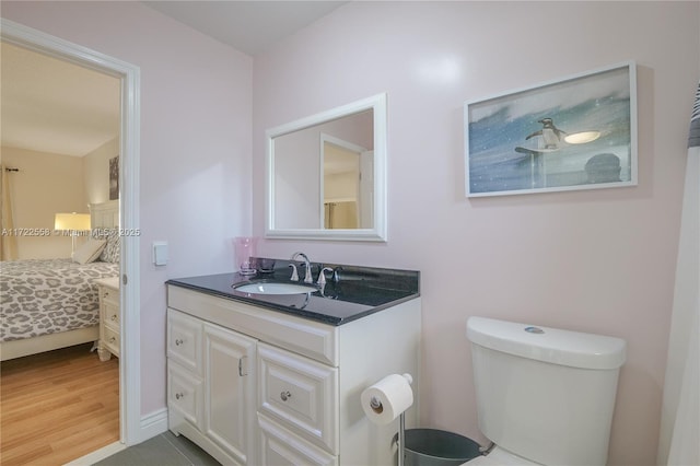 bathroom with tile patterned flooring, vanity, and toilet