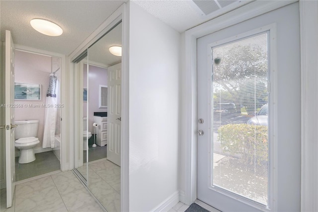 entryway with a textured ceiling