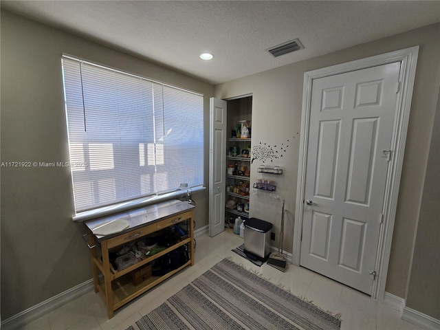 interior space with a textured ceiling