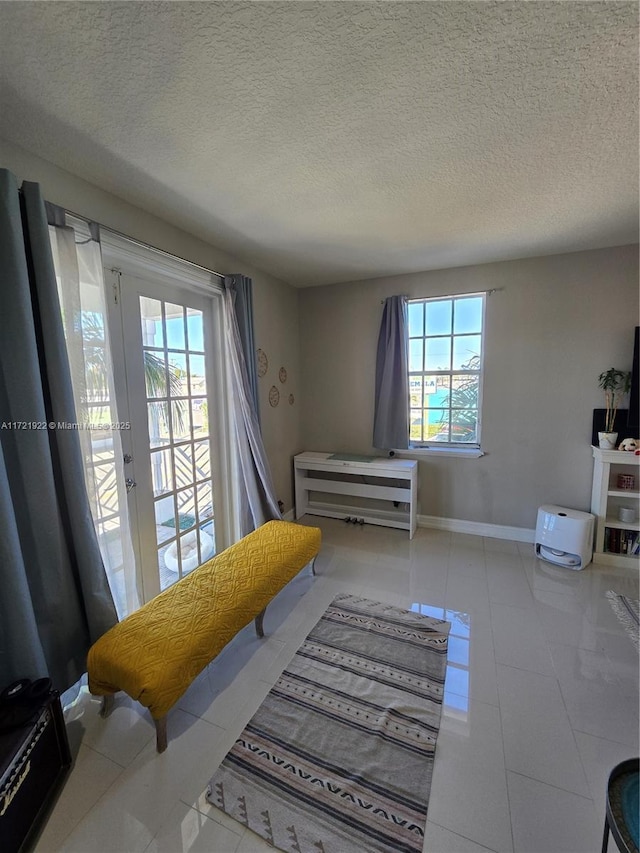 bedroom featuring access to exterior and a textured ceiling