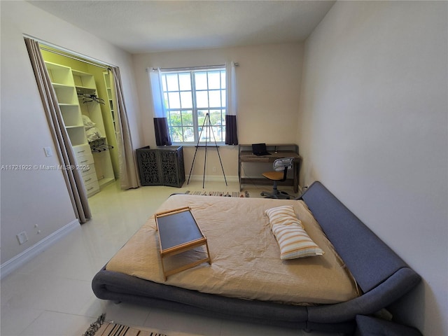 bedroom with a walk in closet and a closet