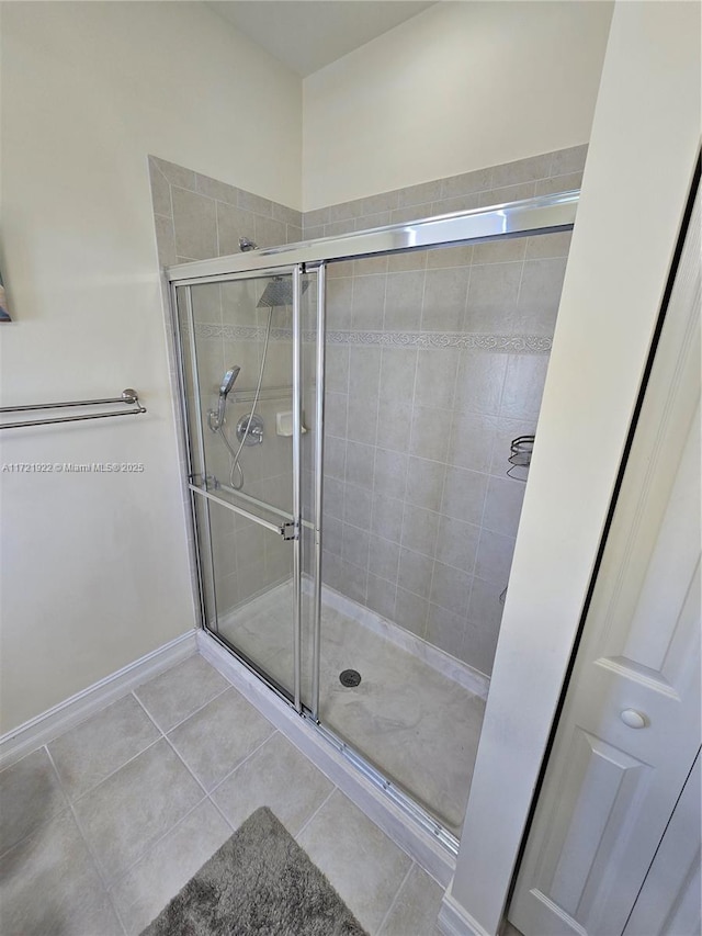 bathroom featuring tile patterned flooring and a shower with door