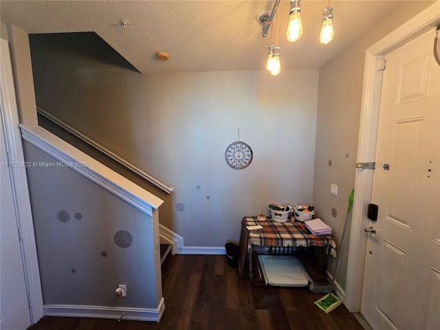 hallway featuring dark hardwood / wood-style flooring and a textured ceiling