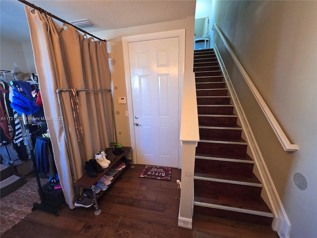 staircase featuring wood-type flooring