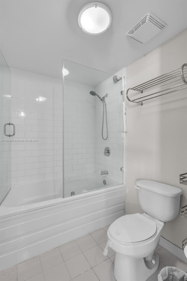 bathroom with toilet, tile patterned floors, and enclosed tub / shower combo