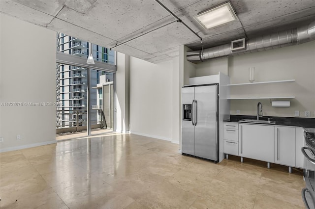 kitchen featuring white cabinets, stainless steel fridge with ice dispenser, sink, and range