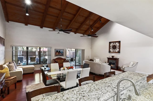 interior space featuring ceiling fan, dark hardwood / wood-style flooring, beamed ceiling, and wooden ceiling