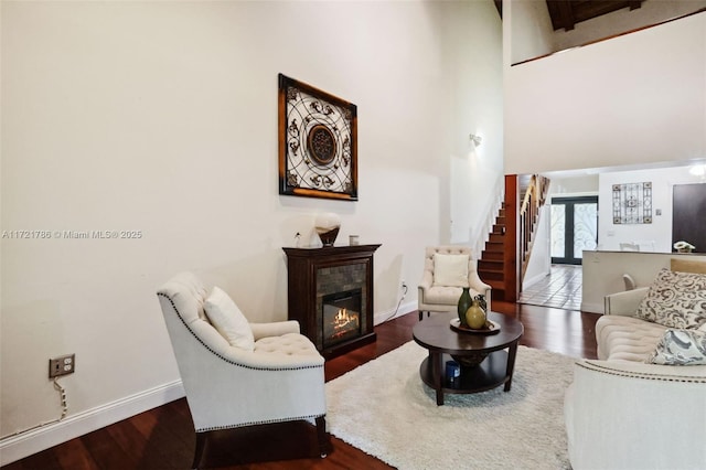 living room with dark hardwood / wood-style floors and a tile fireplace