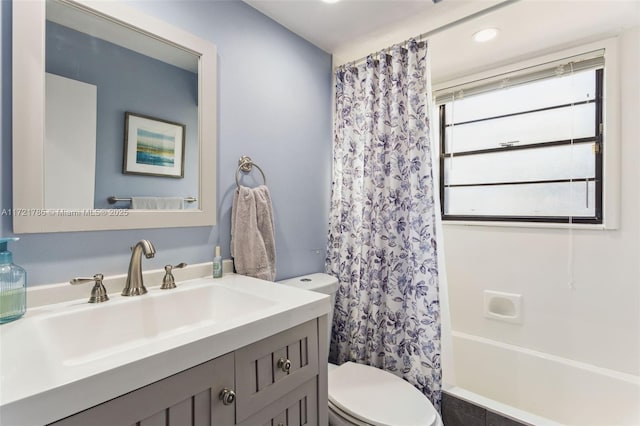 full bathroom with shower / bath combination with curtain, vanity, and toilet