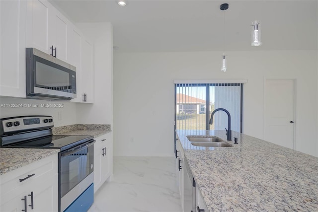 kitchen with sink, stainless steel appliances, light stone counters, pendant lighting, and white cabinets