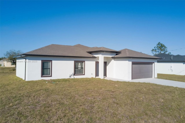 prairie-style home with a garage and a front lawn