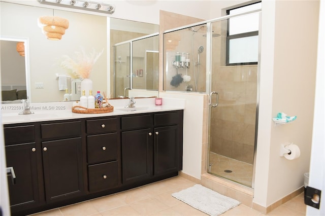 bathroom featuring tile patterned flooring, vanity, and walk in shower