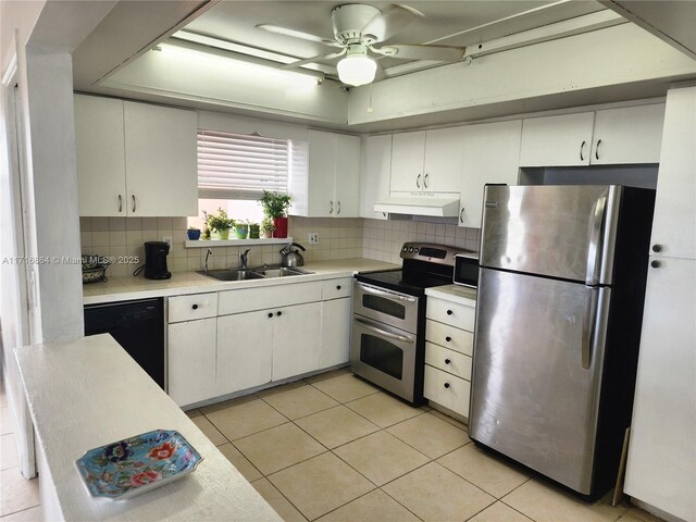 1351 NE Miami Gardens Dr Unit 1025E, Miami, FL 33179 - kitchen featuring appliances with stainless steel finishes, a sink, light countertops, under cabinet range hood, and tasteful backsplash