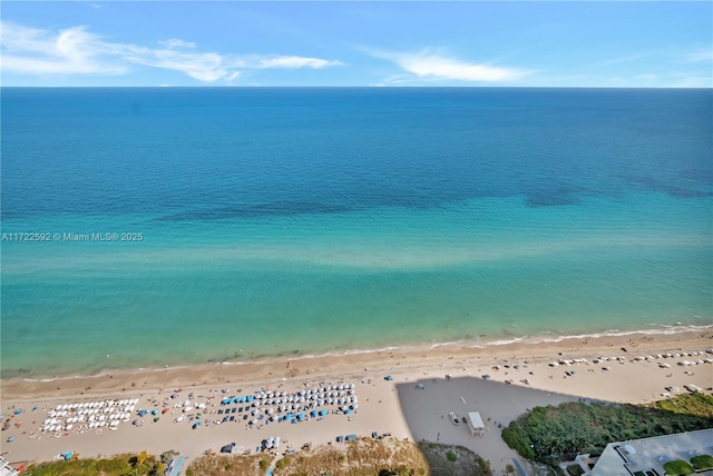 aerial view with a water view and a beach view