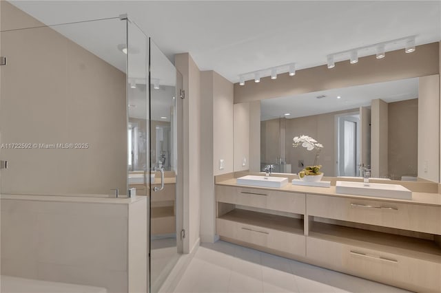 bathroom with tile patterned flooring, vanity, and walk in shower