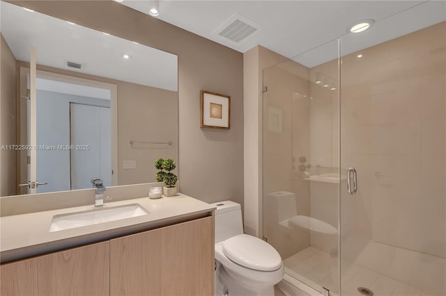 bathroom with an enclosed shower, vanity, and toilet