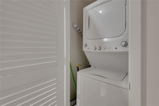 clothes washing area featuring stacked washer / dryer