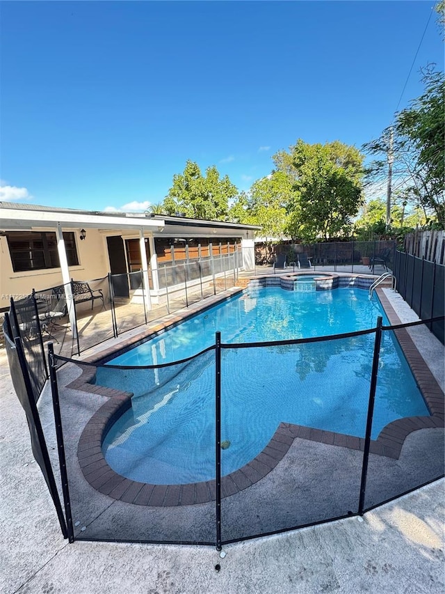 view of pool with a patio area and an in ground hot tub