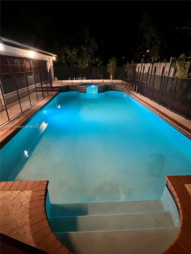 view of pool at night