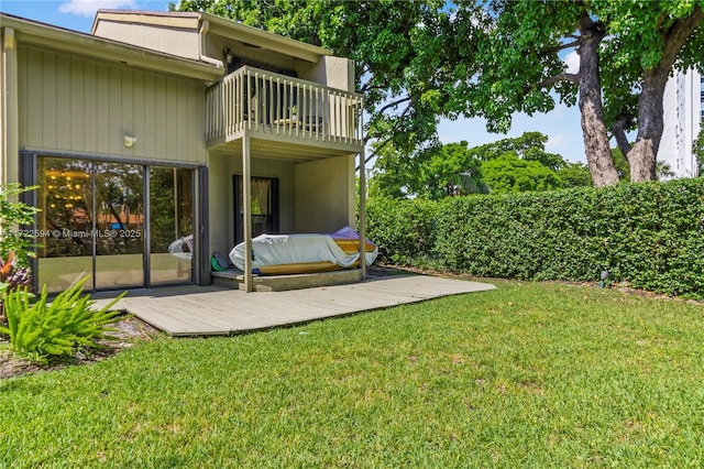 exterior space featuring a balcony and a lawn