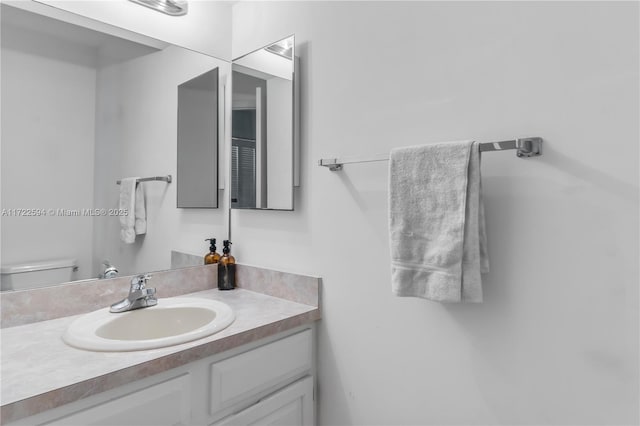 bathroom featuring vanity and toilet