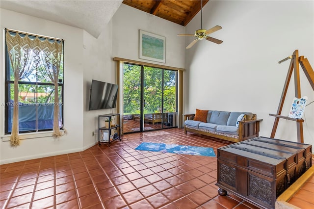 living room with tile patterned flooring, ceiling fan, and a healthy amount of sunlight