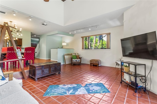 living room with a chandelier and tile patterned floors