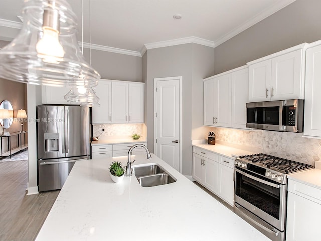 kitchen featuring white cabinets, hanging light fixtures, sink, decorative backsplash, and appliances with stainless steel finishes