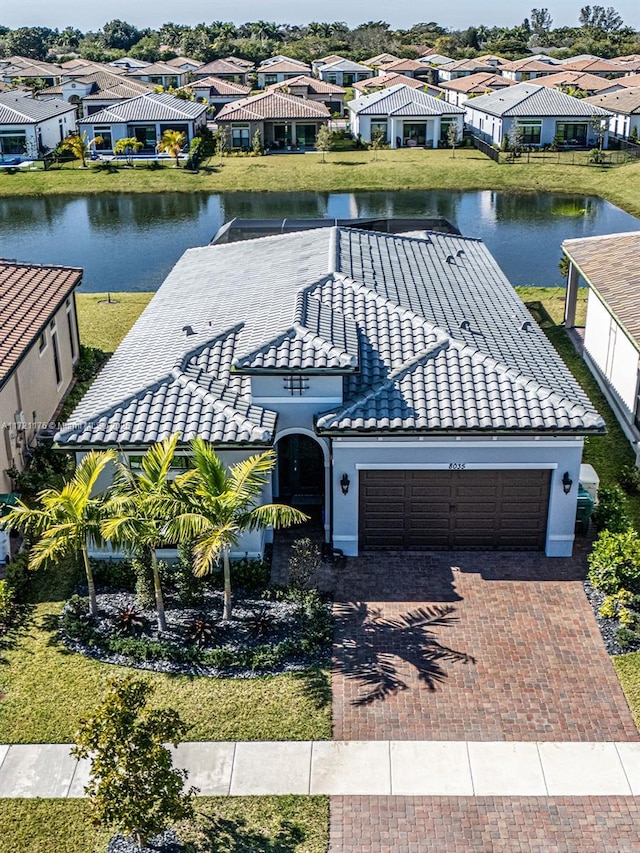 birds eye view of property with a water view